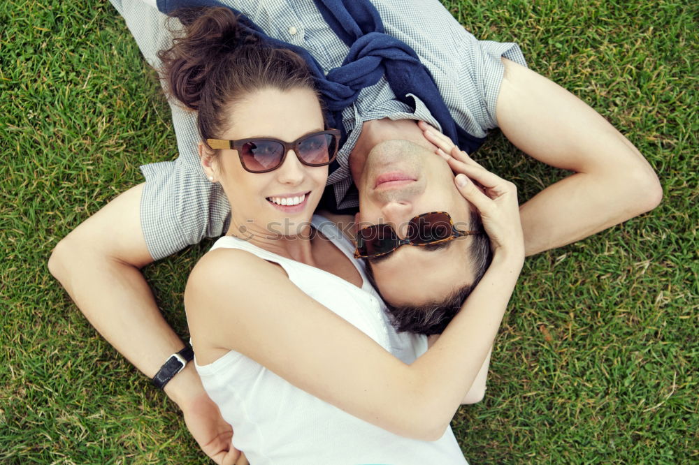 Similar – Couple lying at lake together