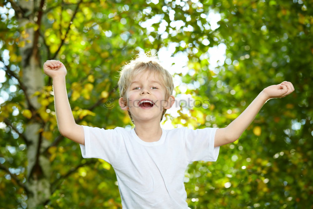 Similar – Funny, funny, cheerful, happy, funny blonde girl outside in the garden, looks up and sticks out her red tongue. Little joker is fooling around, fun with twisted eyes in nature, in the park with flowers and trees.