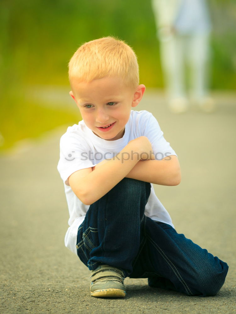 Similar – Happy boy sitting on the floor