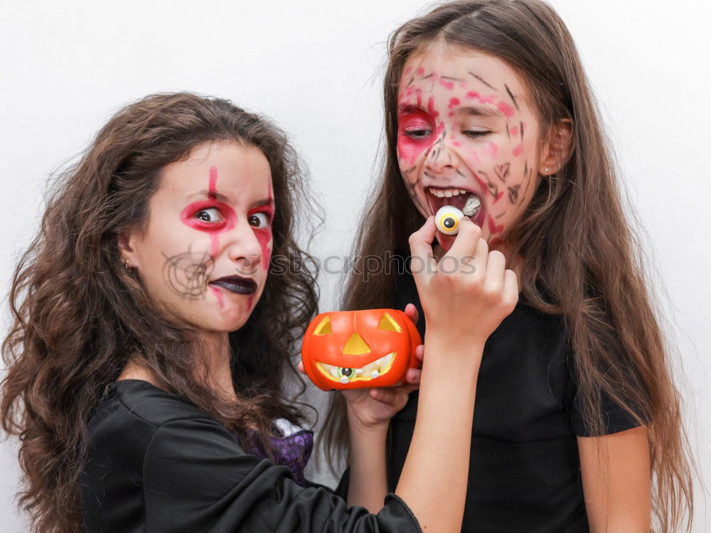 Similar – Image, Stock Photo Happy children disguised decorating a pumpkin at home.