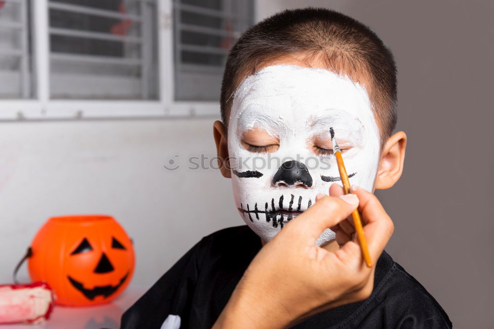 Similar – Image, Stock Photo Happy children disguised decorating a pumpkin at home.