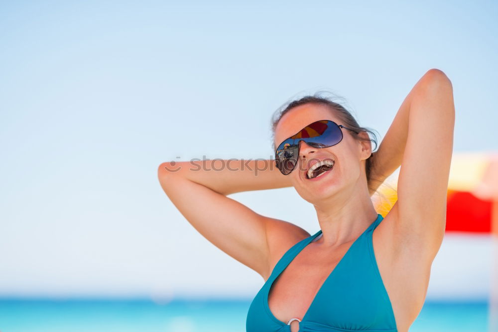 Similar – Woman in bikini sitting on bench near water