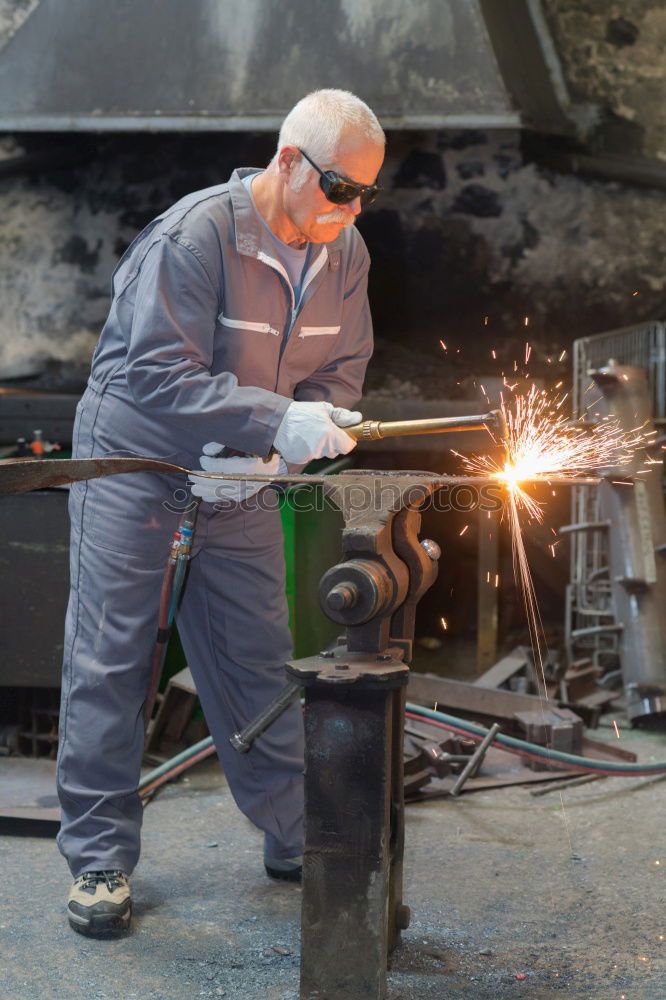 Similar – Man cutting iron