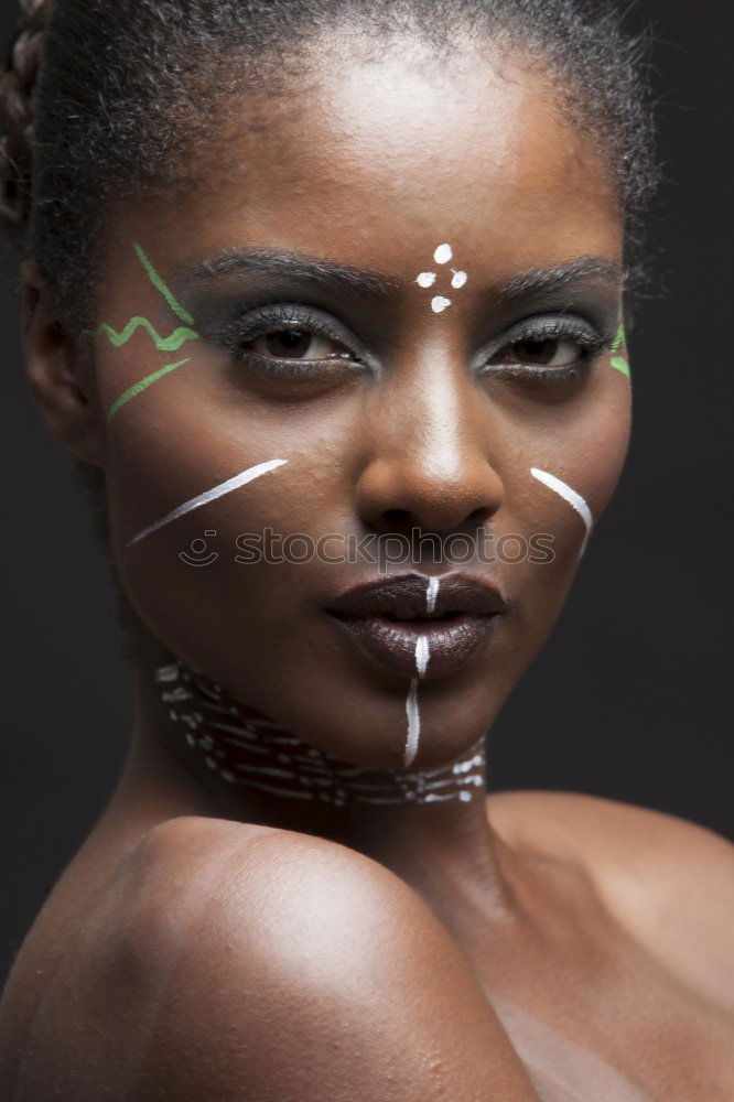 Similar – very close portrait of young beautiful dark skinned woman looking into camera from below