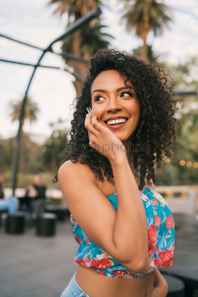 Similar – Smiling young adult woman talking on the phone