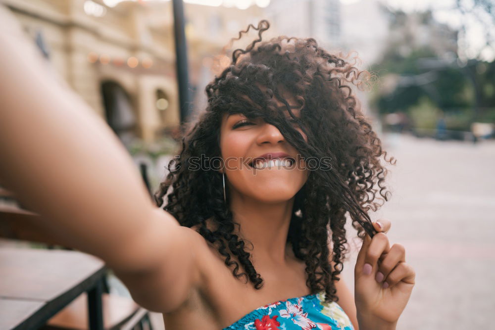 Similar – Young black woman with afro hairstyle smiling in urban park