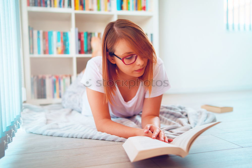 Similar – Image, Stock Photo Young couple reading book on couch at home