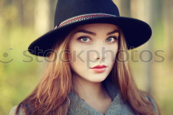 Similar – Young woman sitting on the street