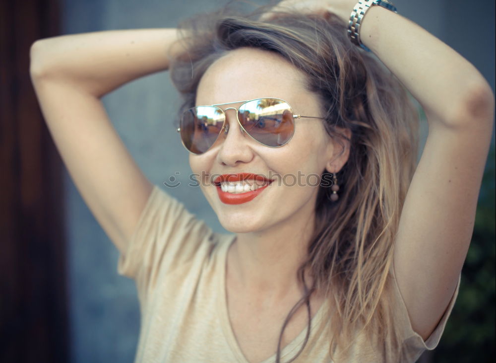 Cheerful brunette woman lying in grass