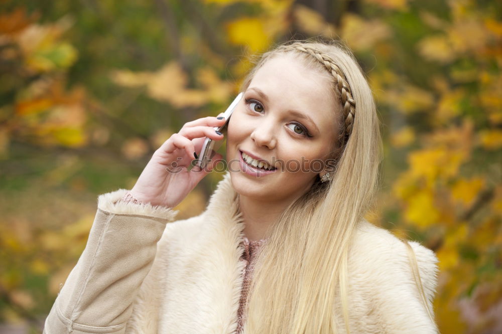 Similar – Image, Stock Photo Smiling young woman chatting on a mobile in autumn