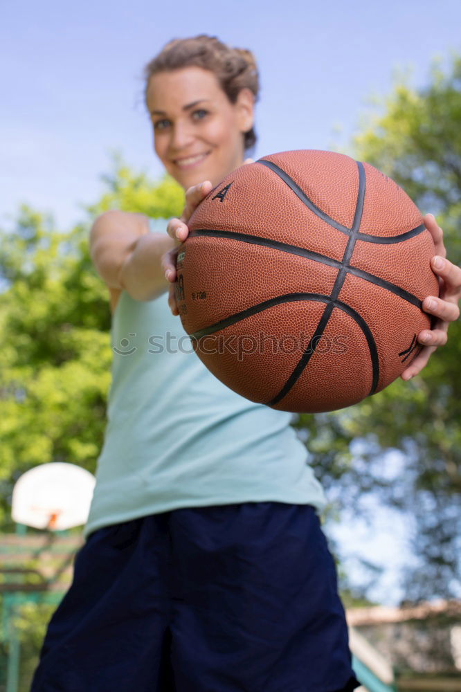 Similar – junge langhaarige Frau hält einen Basketball gegen grüne Wand