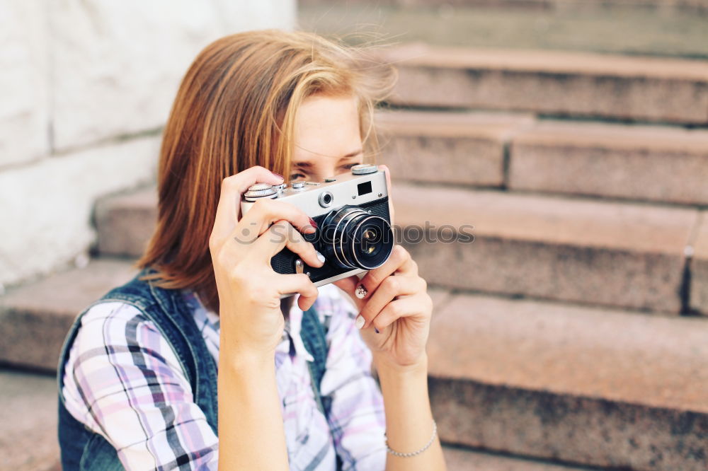 Similar – Young redhead woman taking shots with her analog camera