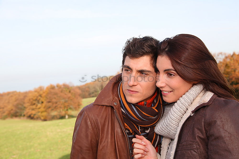 Similar – Young couple embracing and having hot beverage outdoors