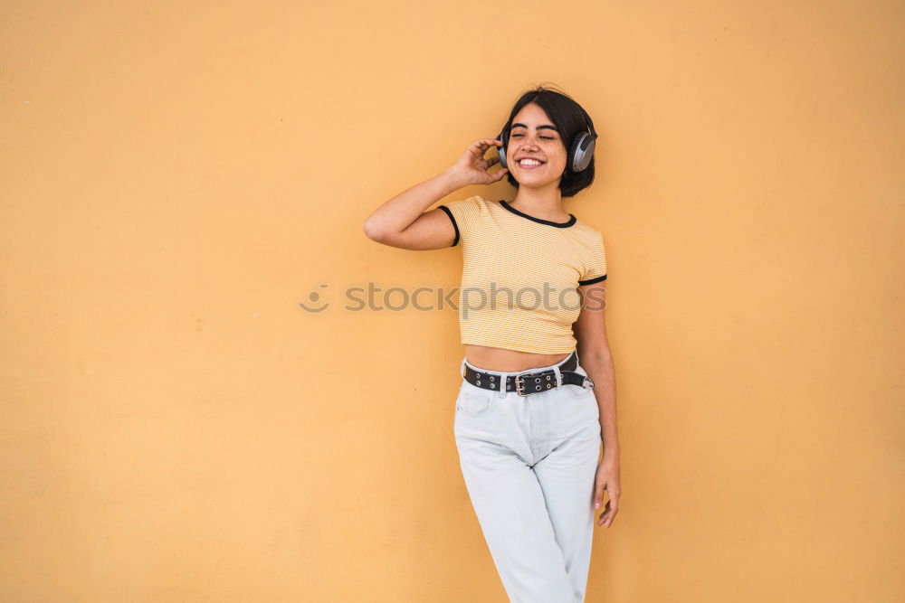 Similar – Portrait of young adult female in front of yellow wall