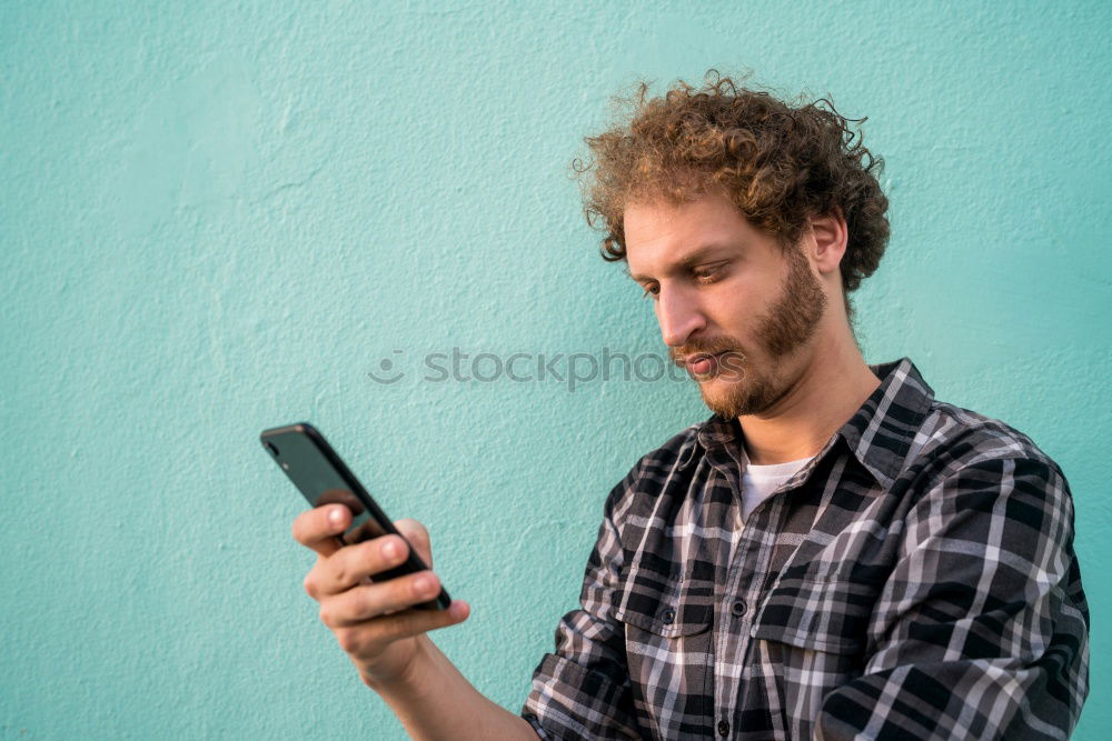 Similar – Man using his mobile phone.