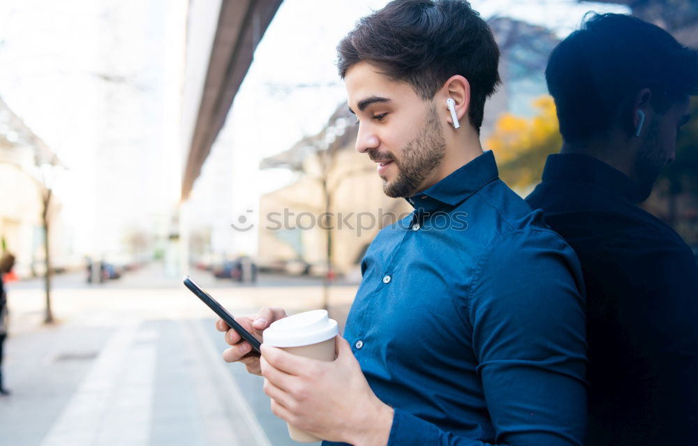 Similar – Image, Stock Photo Young smiling man looking at his smartphone in the street