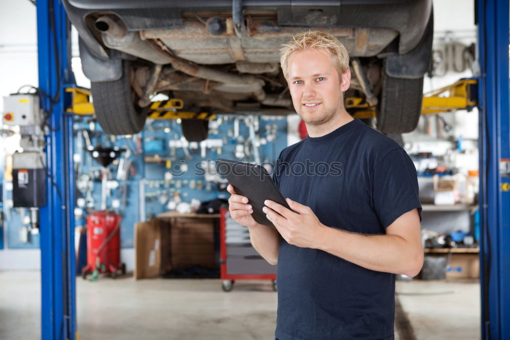 Image, Stock Photo Mechanic checking wheel of a customized motorcycle