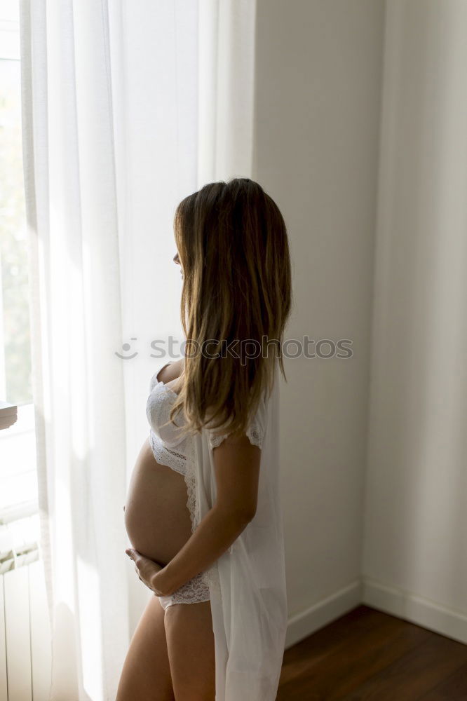 Similar – Image, Stock Photo Female expecting baby sitting on bed