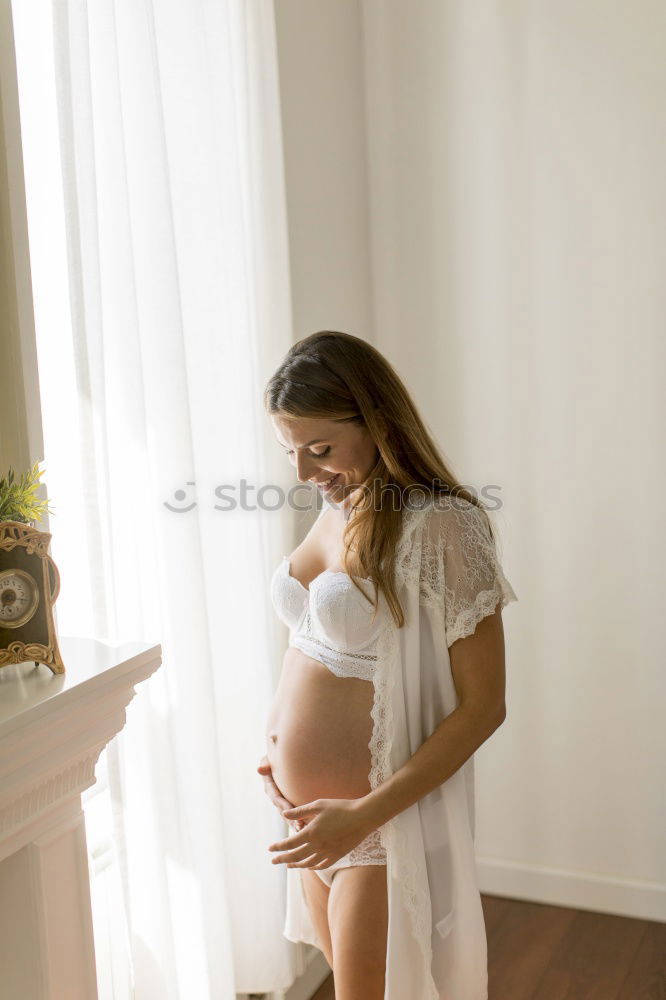 Similar – Pregnant woman touching her belly