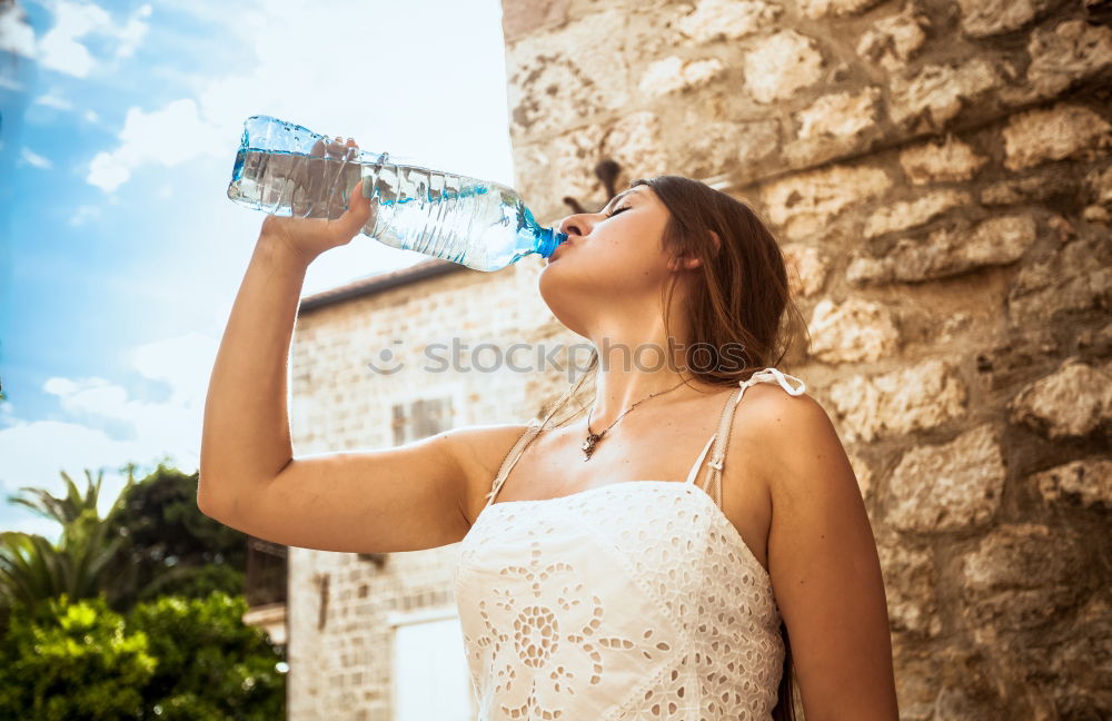 Similar – Fit sporty woman drinking water from a bottle