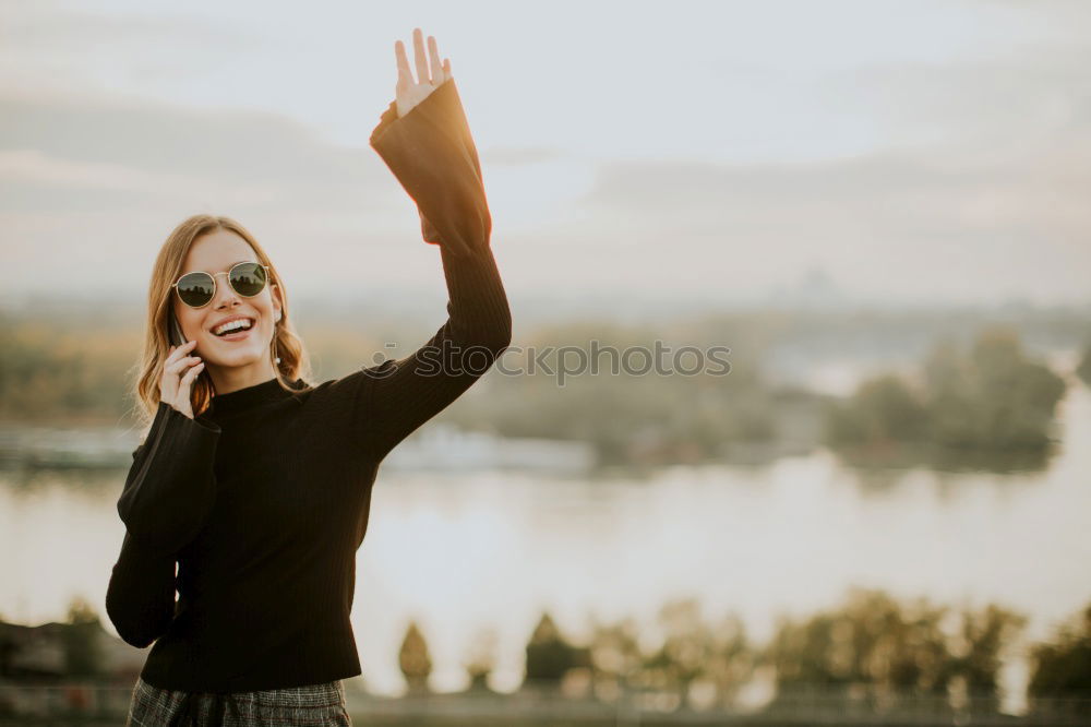 Image, Stock Photo Happy woman sitting outdoors putting her hand near the camera.