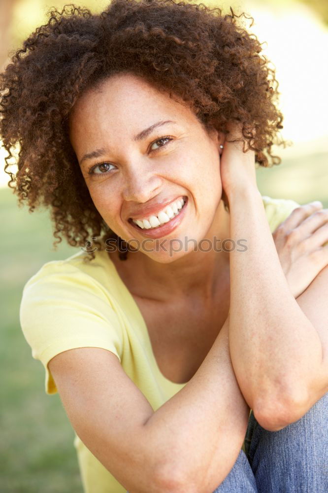 Similar – Mixed woman with afro hairstyle smiling in urban park