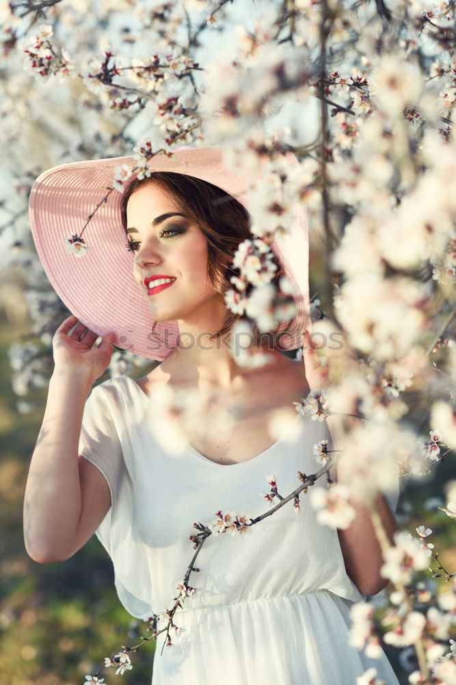 Similar – Young woman in almond flowered field in spring time