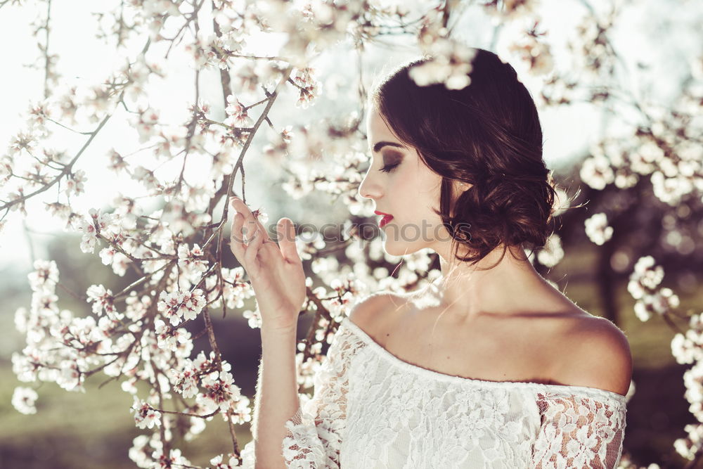 Similar – Young woman smelling almond flowers in springtime