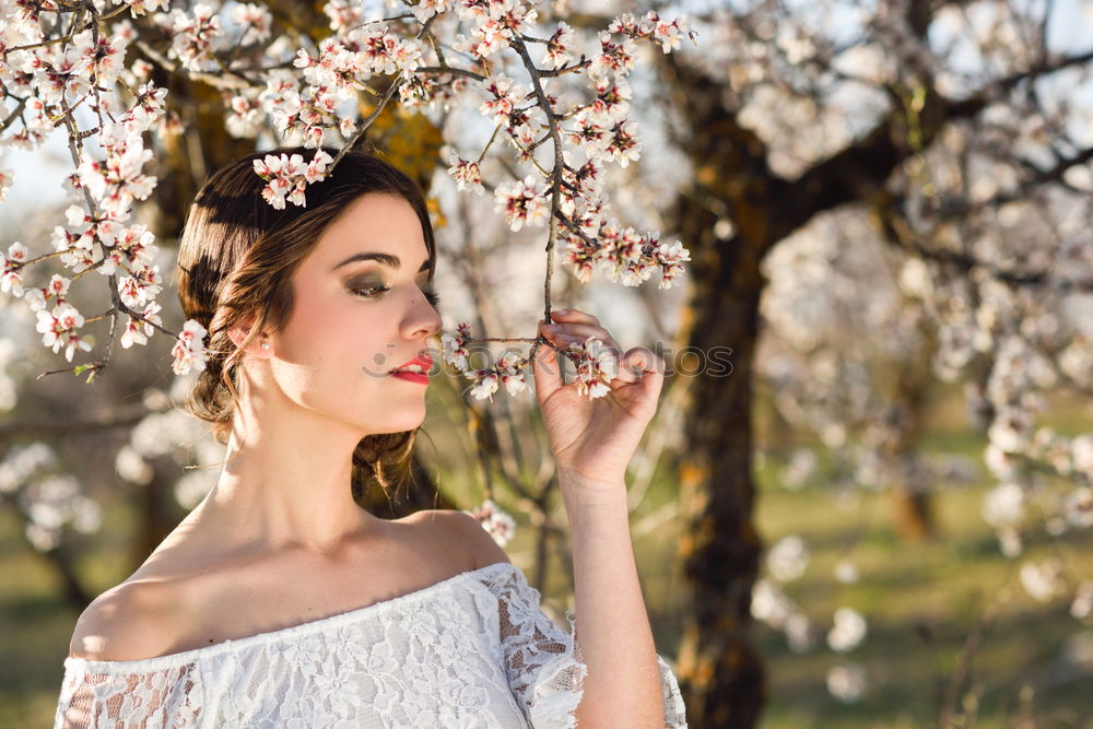 Similar – Young woman in almond flowered field in spring time