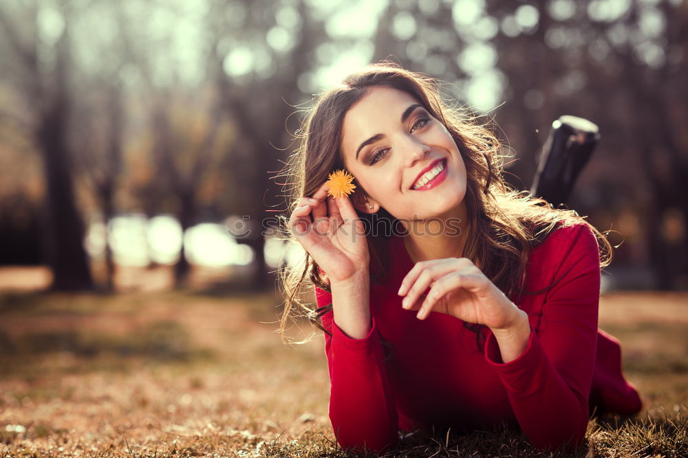 Similar – Cheerful brunette woman lying in grass