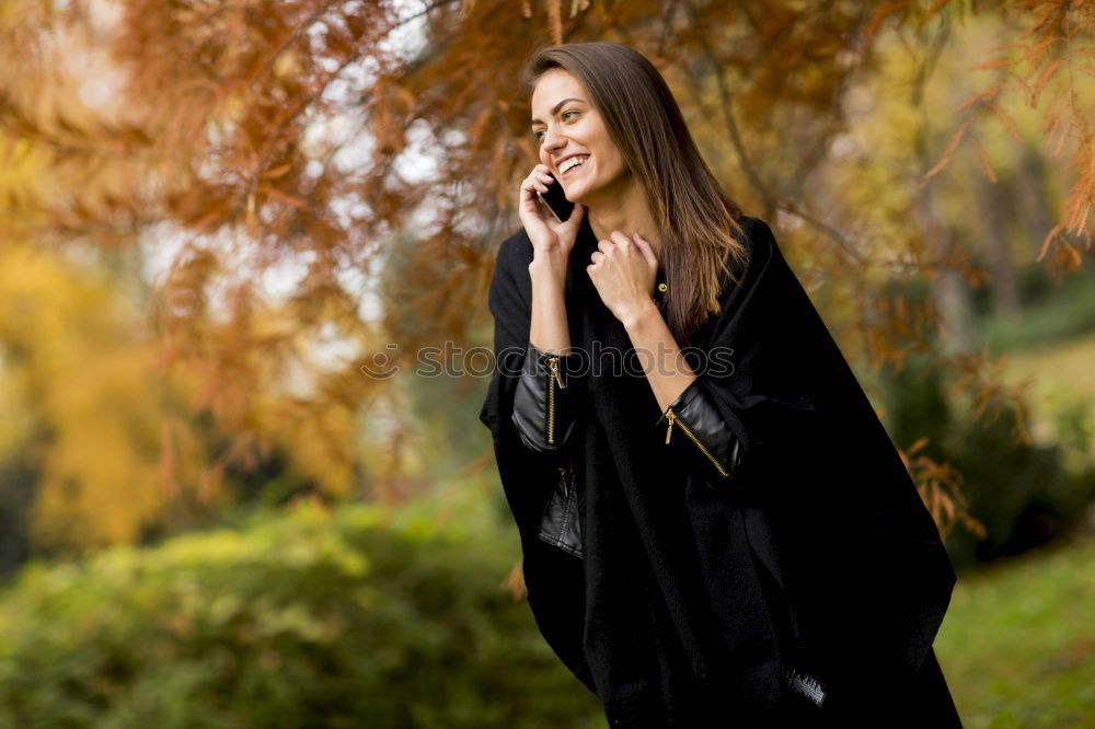 Similar – Image, Stock Photo Smiling young woman chatting on a mobile in autumn