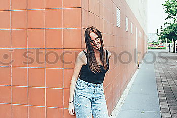 Similar – Portrait of young adult female in front of yellow wall