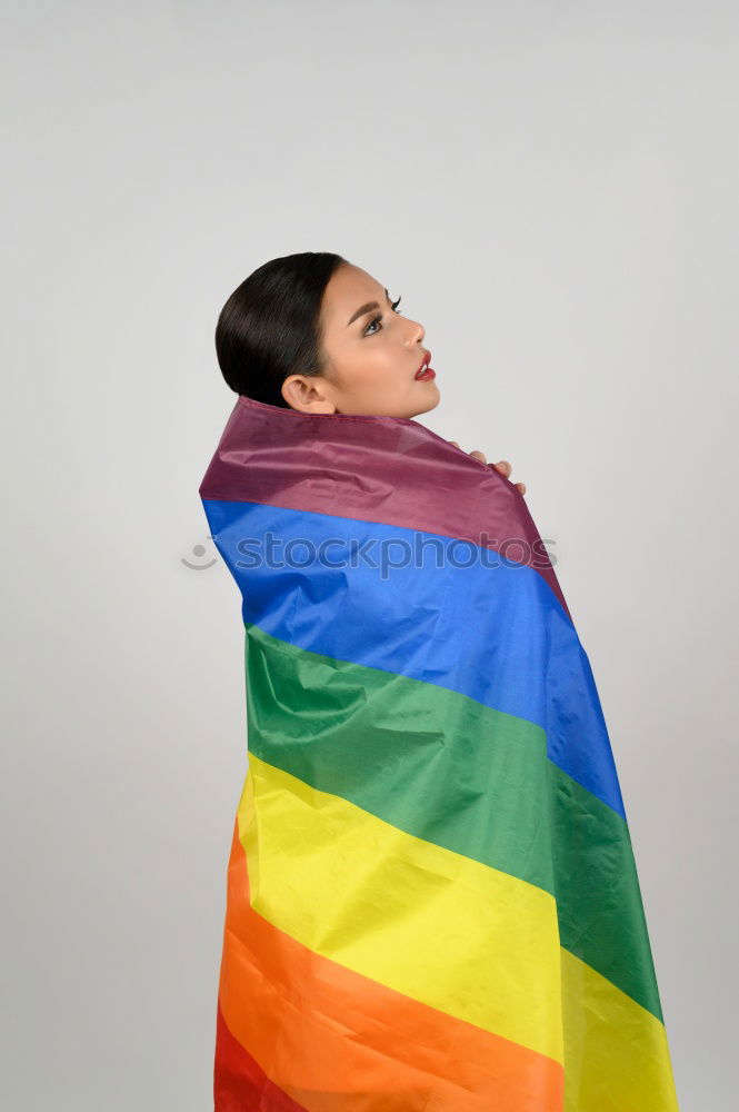 Similar – Image, Stock Photo Young woman holding a rainbow flag behind a fence