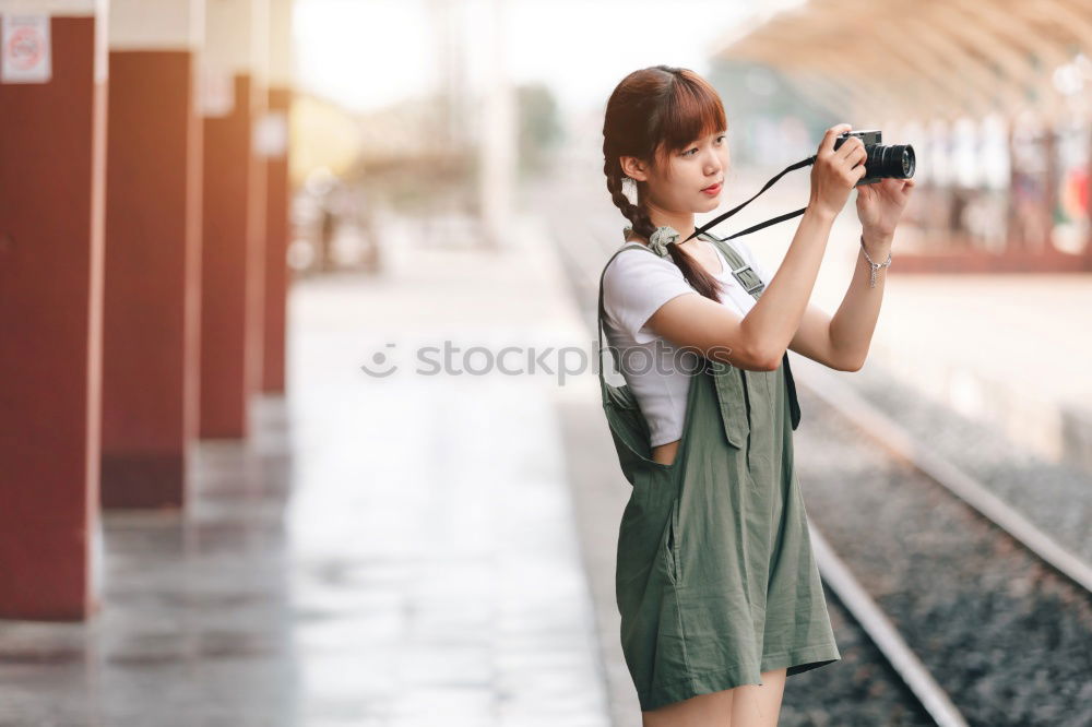 Similar – Close up of a photographer with her camera.