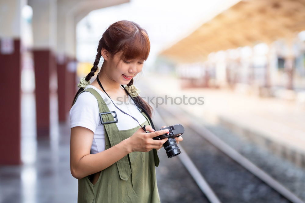 Similar – Image, Stock Photo Young woman with mobile phone at train station