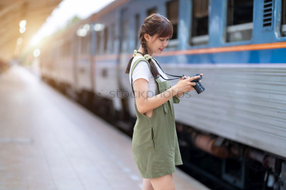 Similar – Image, Stock Photo Young woman with mobile phone at train station