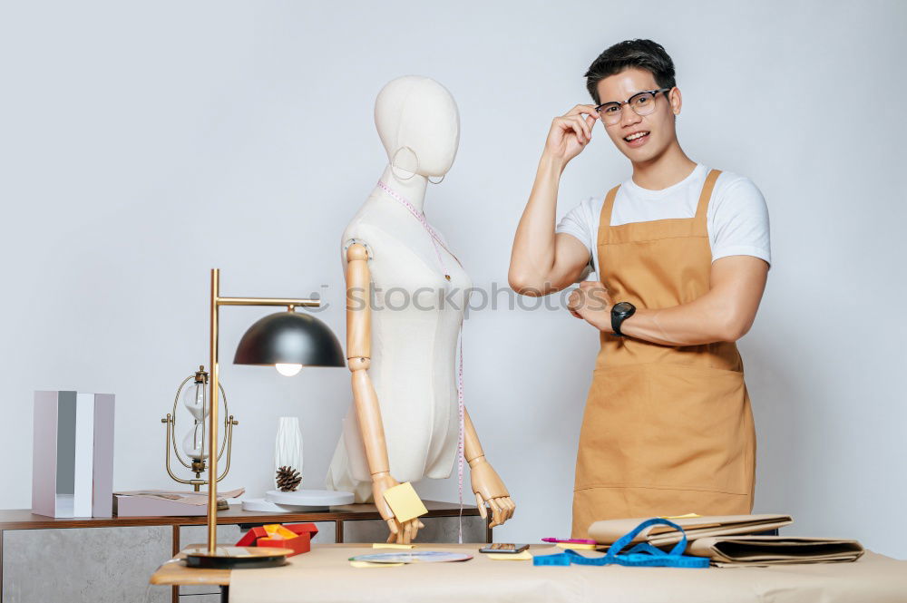 Similar – Image, Stock Photo Woman in work wear in her workshop by table with handmade items