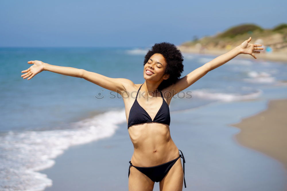 Similar – Young woman in bikini on a tropical beach with open arms.