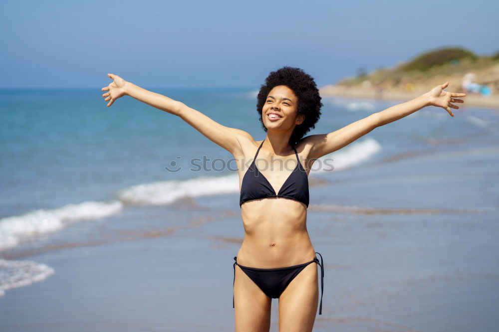 Similar – Young woman in bikini on a tropical beach with open arms.