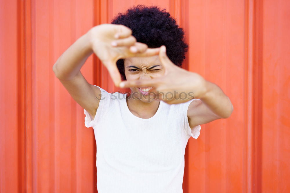 Similar – Image, Stock Photo Young beautiful Afro-American woman posing and smiling while standing against brick wall