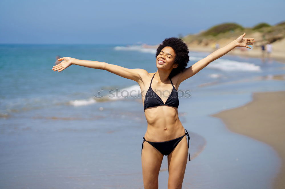 Similar – Young woman in bikini on a tropical beach with open arms.