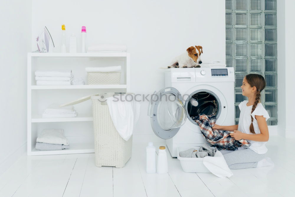 Woman sitting at laundry machine