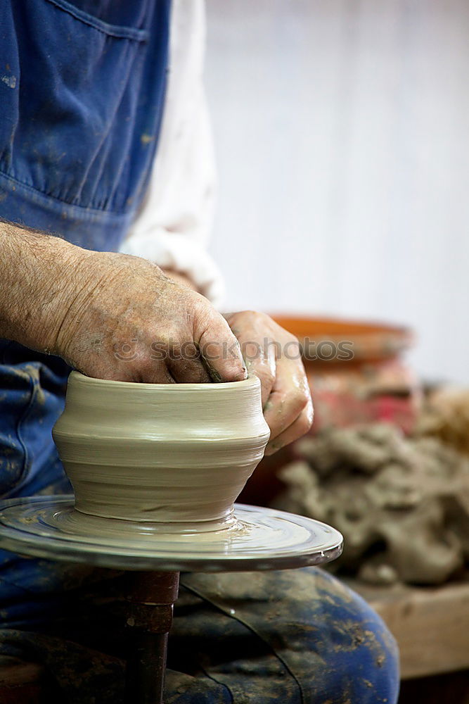 Similar – Image, Stock Photo Potter’s hands making a pot in a traditional style.