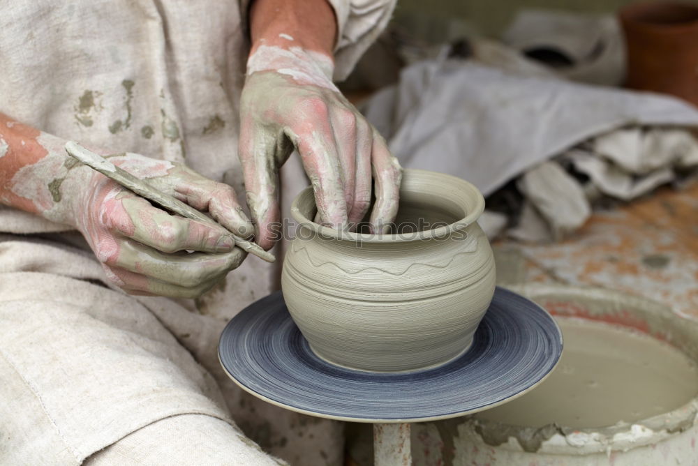 Image, Stock Photo Potter’s hands making a pot in a traditional style.