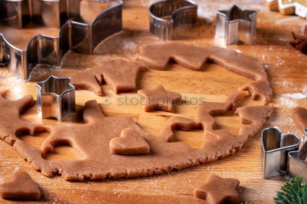 Similar – Cooking Christmas cookies with cookie cutters on a dark table