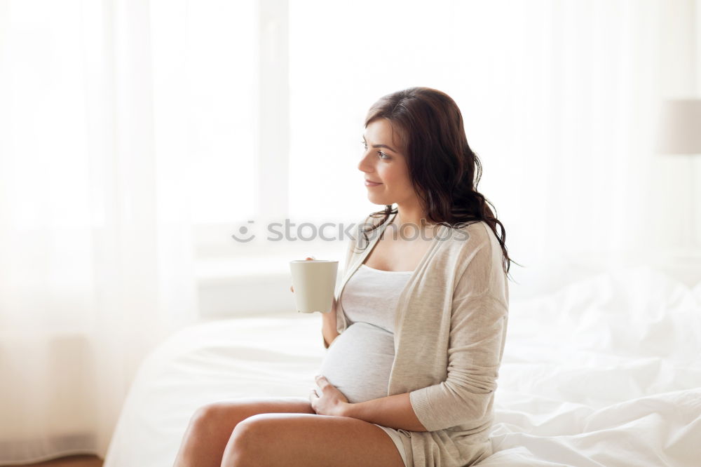 Similar – Pregnant woman touching her belly