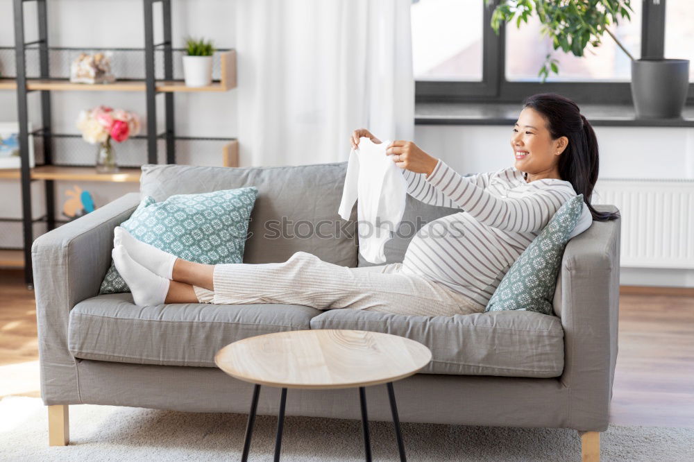 Similar – woman with laptop on her sofa at home