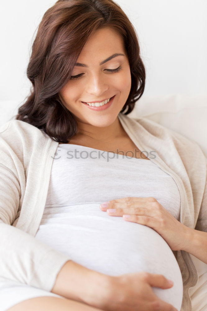 Similar – Pregnant woman touching her belly