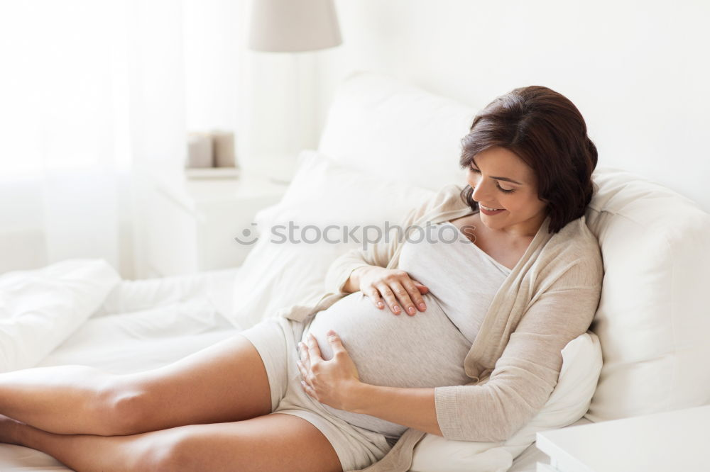 Similar – Pregnant woman touching her belly