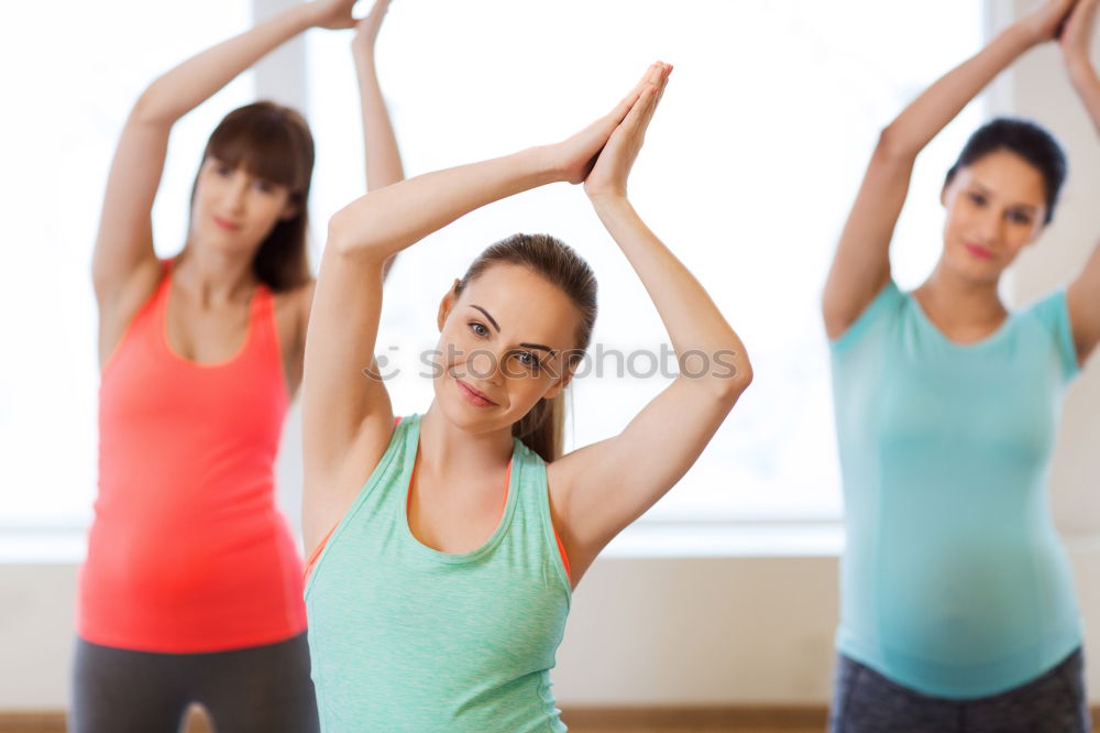 Similar – Group of young sporty attractive women in yoga studio, practicing yoga lesson with instructor, standing, stretching and relaxing after workout . Healthy active lifestyle, working out indoors in gym